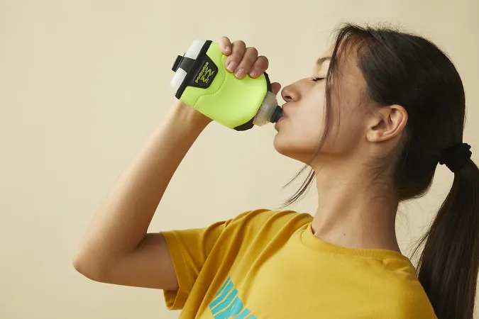 A woman drinking from a water bottle