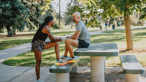 A man and woman chat before a run. 