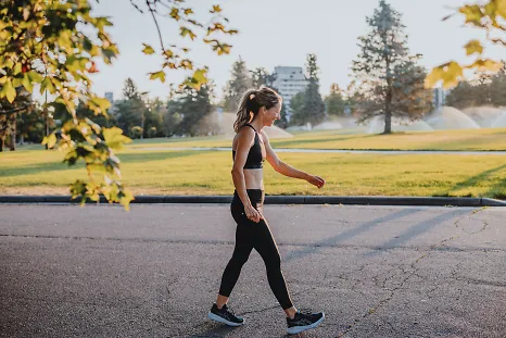 A woman walks after finishing up her run.