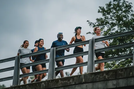 People running on a bridge